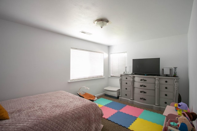 bedroom with visible vents, baseboards, and carpet floors