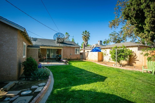 view of yard with a fenced backyard and a patio area