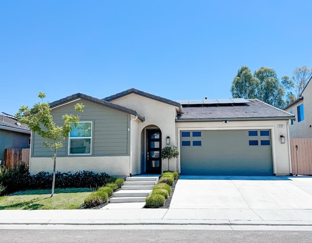 3395 Las Rosas Ave, Clovis, CA 93619 - ranch-style house with an attached garage, solar panels, driveway, and stucco siding