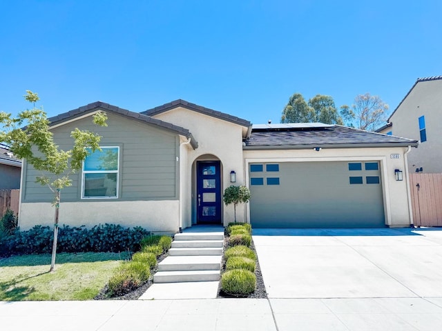 3395 Las Rosas Ave, Clovis, CA 93619 - single story home with a garage, roof mounted solar panels, driveway, and stucco siding