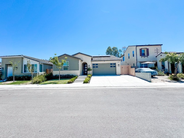 3395 Las Rosas Ave, Clovis, CA 93619 - ranch-style home featuring solar panels, a garage, driveway, and stucco siding