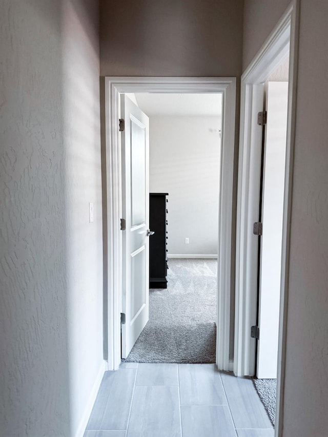 3395 Las Rosas Ave, Clovis, CA 93619 - hallway with light carpet and light tile patterned floors