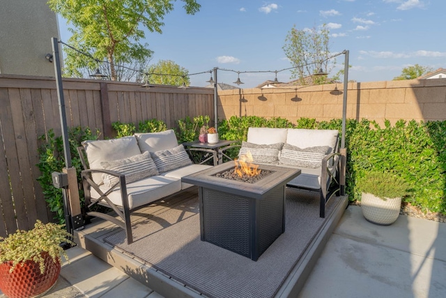 view of patio featuring an outdoor living space with a fire pit and a fenced backyard