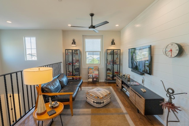 living room featuring wood finished floors, a ceiling fan, and plenty of natural light