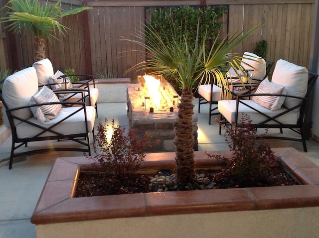 view of patio / terrace featuring an outdoor fire pit and fence