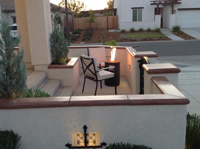 view of patio / terrace with a fire pit and fence