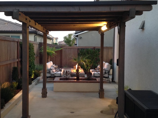 view of patio / terrace featuring fence and a fire pit