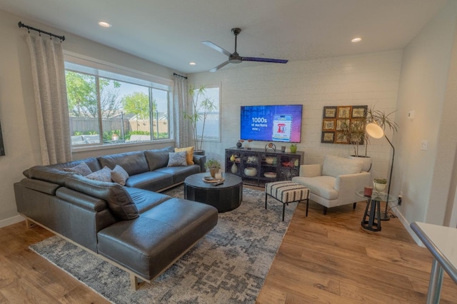 living room featuring wood finished floors, ceiling fan, baseboards, and recessed lighting