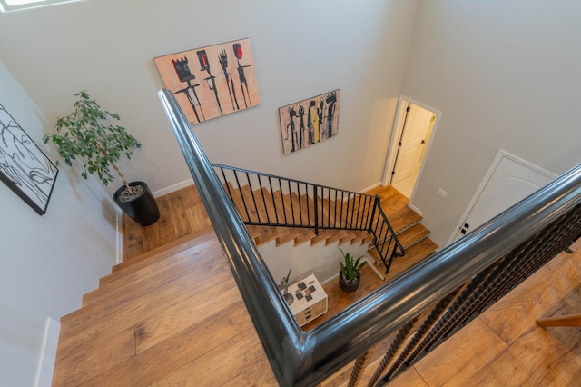 stairway featuring baseboards and wood finished floors