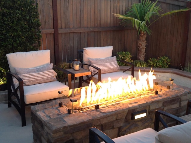 view of patio with fence and a fire pit