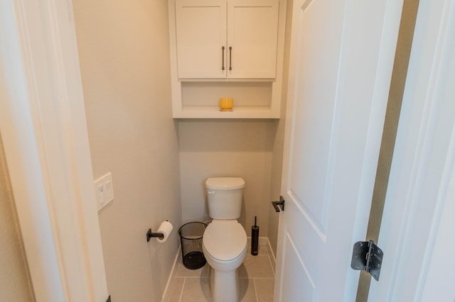 bathroom featuring toilet and tile patterned flooring