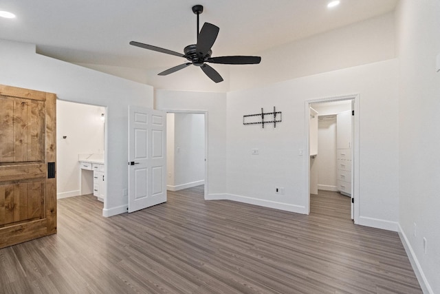 1125 N Purdue Ave, Clovis, CA 93611 - unfurnished bedroom featuring wood finished floors, baseboards, ensuite bathroom, and recessed lighting