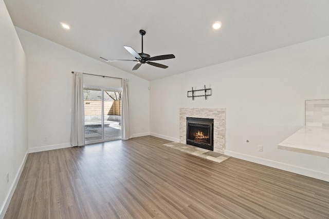 1125 N Purdue Ave, Clovis, CA 93611 - unfurnished living room with lofted ceiling, wood finished floors, baseboards, a ceiling fan, and a fireplace with flush hearth