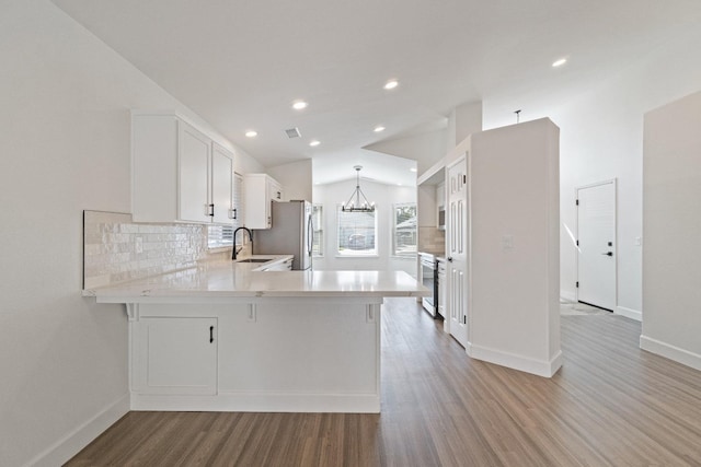 1125 N Purdue Ave, Clovis, CA 93611 - kitchen featuring light wood-style flooring, baseboards, light countertops, freestanding refrigerator, and recessed lighting