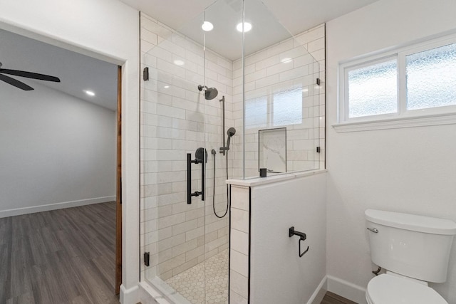 1125 N Purdue Ave, Clovis, CA 93611 - full bathroom featuring a stall shower, toilet, ceiling fan, wood finished floors, and baseboards