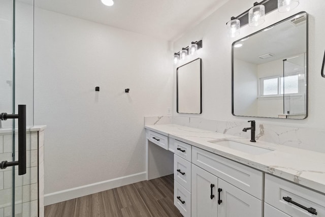 1125 N Purdue Ave, Clovis, CA 93611 - full bath with vanity, wood finished floors, and baseboards