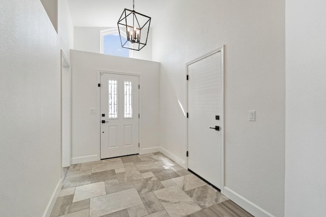 1125 N Purdue Ave, Clovis, CA 93611 - foyer entrance with a high ceiling, baseboards, and a chandelier
