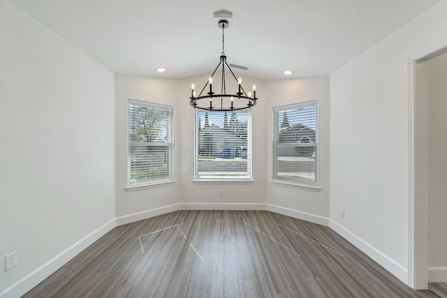 1125 N Purdue Ave, Clovis, CA 93611 - unfurnished dining area with a chandelier, wood finished floors, baseboards, and recessed lighting