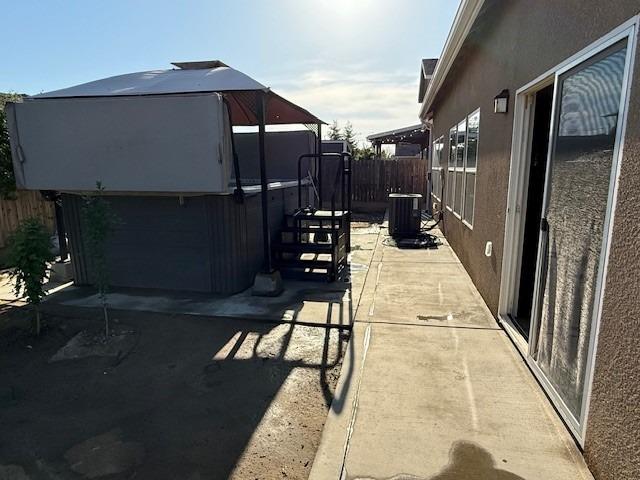 exterior space with a gazebo, a patio, central AC unit, and fence