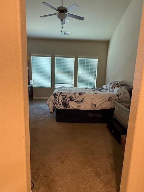 bedroom featuring visible vents, a ceiling fan, and carpet floors