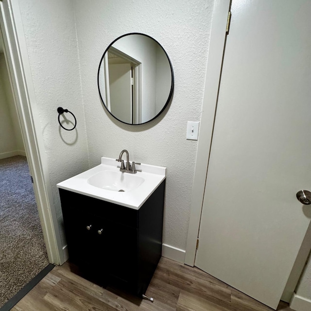 bathroom with vanity and wood finished floors