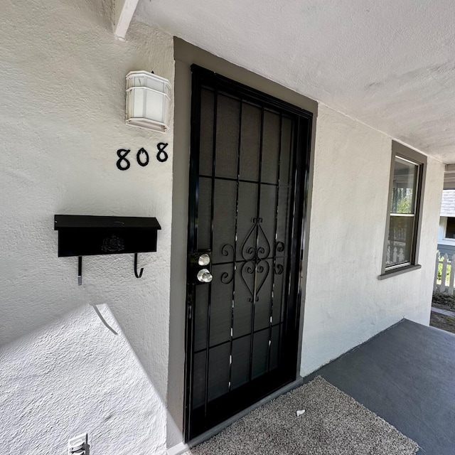 entrance to property with stucco siding