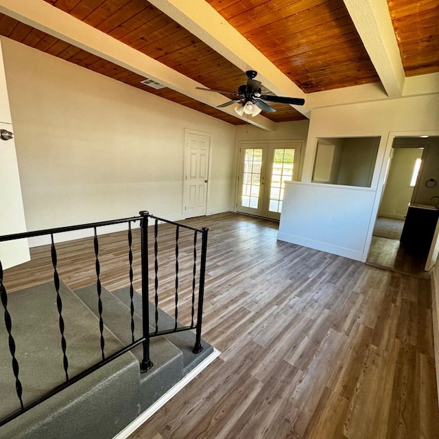 unfurnished living room featuring a ceiling fan, visible vents, wooden ceiling, french doors, and beam ceiling
