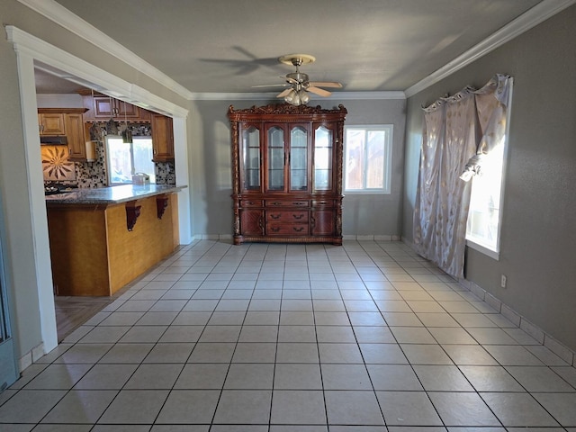 3525 Mayfair Dr N, Fresno, CA 93703 - unfurnished dining area with light tile patterned floors, ceiling fan, and crown molding
