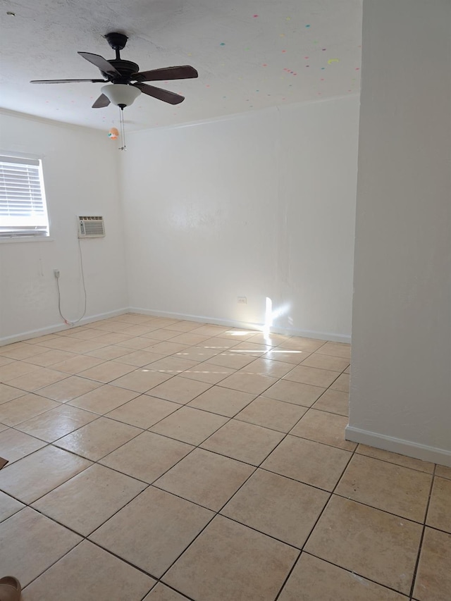 3525 Mayfair Dr N, Fresno, CA 93703 - unfurnished room with light tile patterned floors, an AC wall unit, ceiling fan, and baseboards