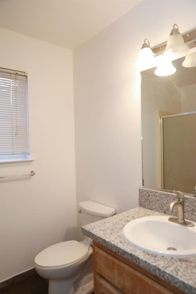 5157 E Truman Ave, Fresno, CA 93725 - full bathroom featuring vanity, a shower stall, toilet, and wood finished floors
