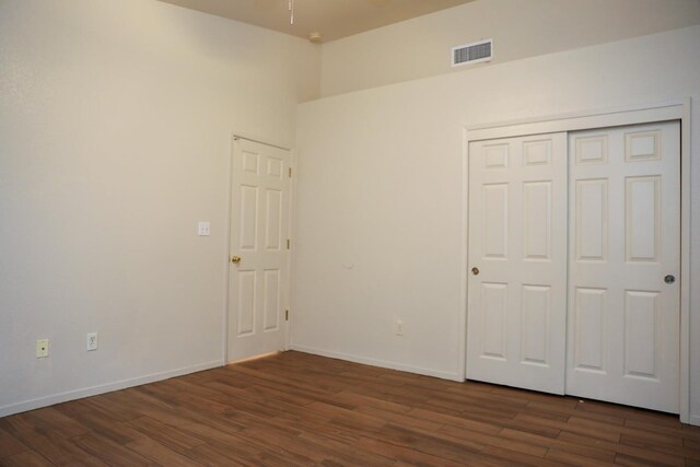 5157 E Truman Ave, Fresno, CA 93725 - unfurnished bedroom with dark wood-type flooring, baseboards, and a closet