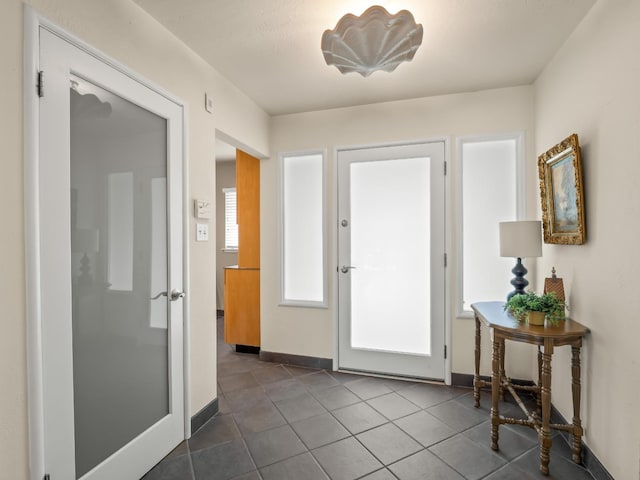 6043 N Forkner Ave, Fresno, CA 93711 - entryway with baseboards and dark tile patterned flooring