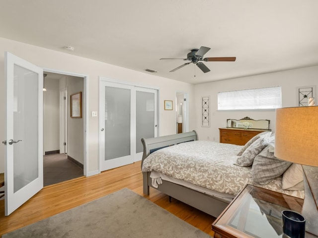 6043 N Forkner Ave, Fresno, CA 93711 - bedroom with wood finished floors, a closet, ceiling fan, and french doors