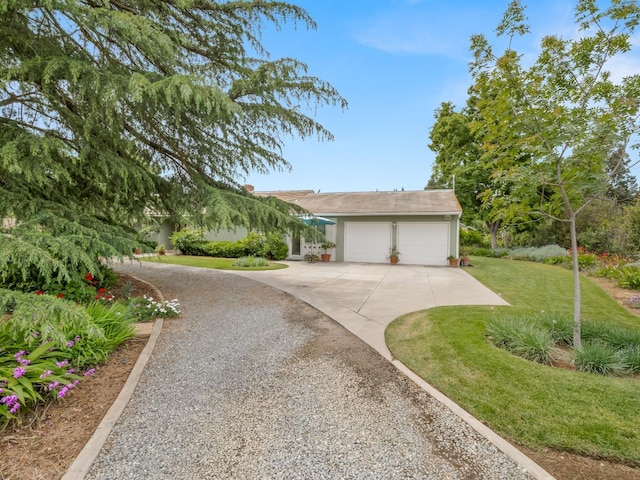 6043 N Forkner Ave, Fresno, CA 93711 - view of front of house featuring driveway, an attached garage, and a front yard
