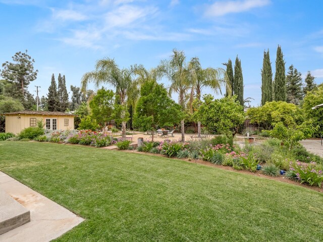 6043 N Forkner Ave, Fresno, CA 93711 - view of green lawn featuring a patio