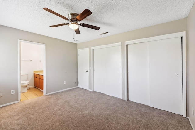 704 Rosehill Dr, Chowchilla, CA 93610 - unfurnished bedroom with visible vents, baseboards, multiple closets, ensuite bath, and light carpet