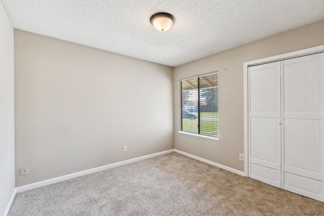 704 Rosehill Dr, Chowchilla, CA 93610 - unfurnished bedroom with carpet flooring, a textured ceiling, and baseboards
