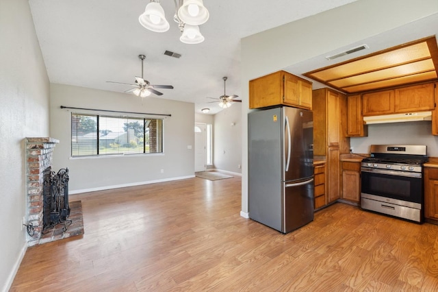704 Rosehill Dr, Chowchilla, CA 93610 - kitchen featuring visible vents, under cabinet range hood, brown cabinets, stainless steel appliances, and light wood-style flooring