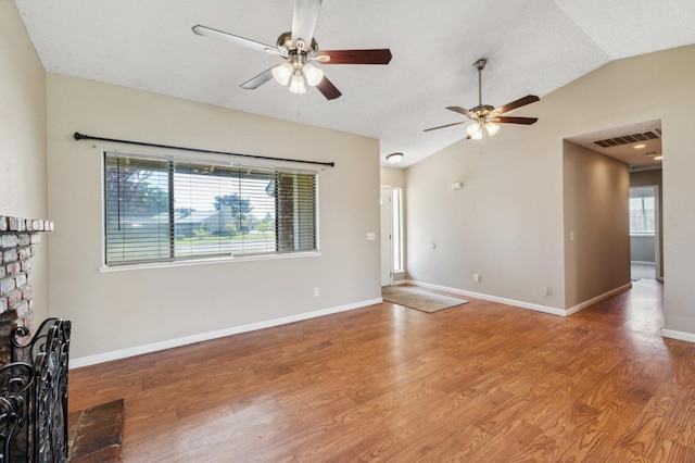 704 Rosehill Dr, Chowchilla, CA 93610 - unfurnished living room featuring visible vents, a wealth of natural light, a ceiling fan, and wood finished floors