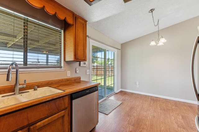 704 Rosehill Dr, Chowchilla, CA 93610 - kitchen featuring decorative light fixtures, a sink, light wood-type flooring, brown cabinetry, and stainless steel dishwasher