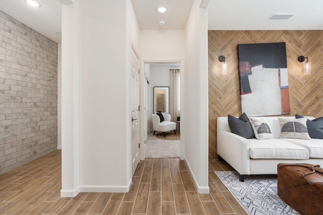 1899 N Apricot Ave, Fresno, CA 93727 - corridor with wood finished floors, brick wall, and baseboards