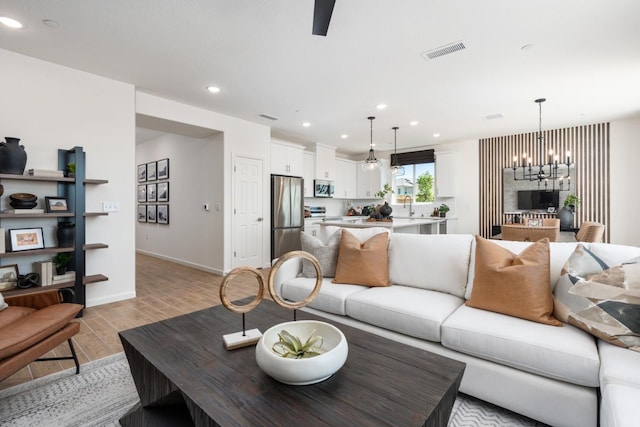 1899 N Apricot Ave, Fresno, CA 93727 - living area with a chandelier, light wood-type flooring, recessed lighting, and baseboards