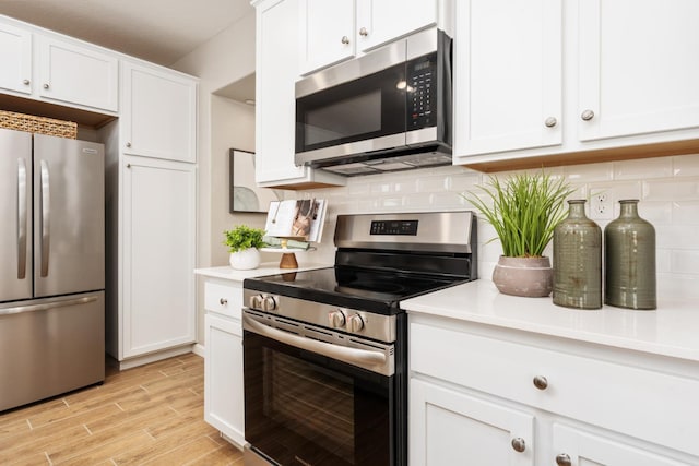 2110 N Brindac Ln, Clovis, CA 93619 - kitchen featuring appliances with stainless steel finishes, tasteful backsplash, light wood-type flooring, and light countertops