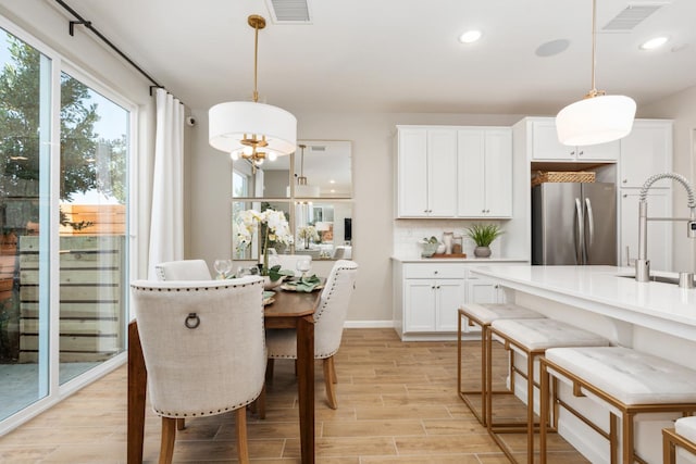 2110 N Brindac Ln, Clovis, CA 93619 - dining room featuring light wood-type flooring, recessed lighting, and a chandelier