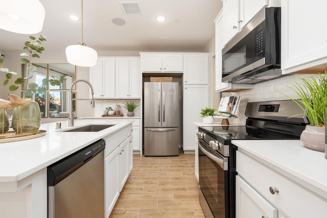 2110 N Brindac Ln, Clovis, CA 93619 - kitchen with stainless steel appliances, tasteful backsplash, light countertops, light wood-style flooring, and recessed lighting