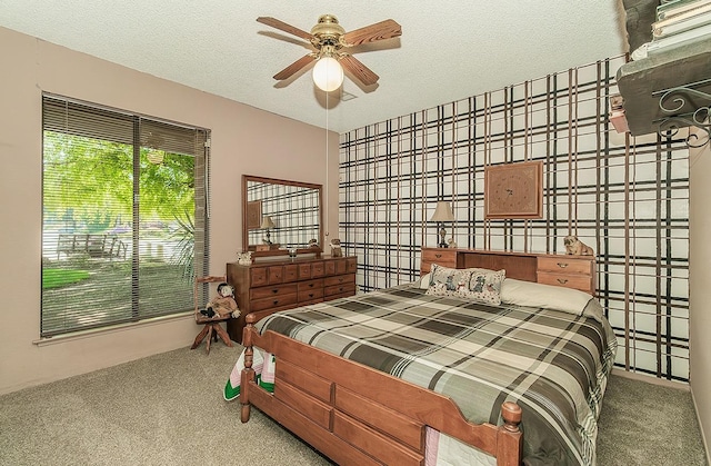 bedroom featuring a textured ceiling and carpet flooring