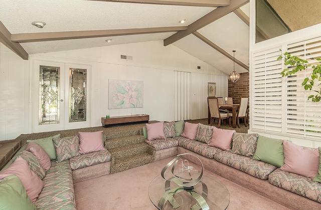 living area with carpet flooring, lofted ceiling with beams, visible vents, and a notable chandelier