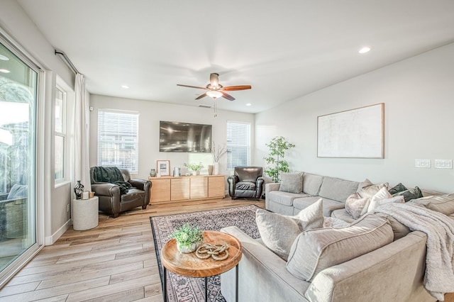 living room featuring light wood finished floors, a wealth of natural light, ceiling fan, and recessed lighting