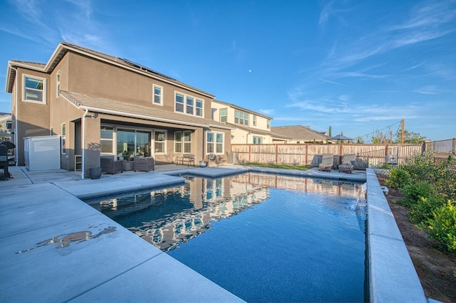 view of swimming pool featuring a patio area, a fenced in pool, outdoor lounge area, and a fenced backyard