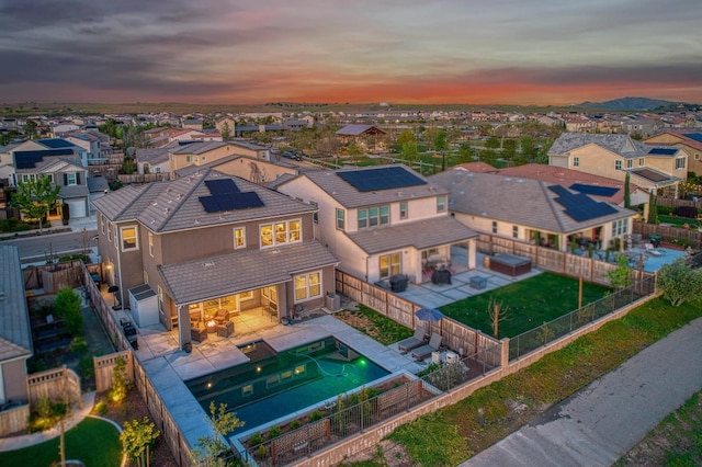 aerial view at dusk featuring a residential view